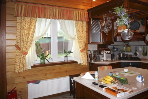 Záclony v rustikálním stylu přispívají k vytvoření teplé a příjemné atmosféry v této kuchyni