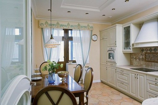 Curtains with a lambrequin in the kitchen with a balcony perform an important decorative function