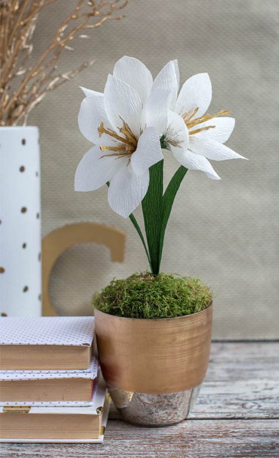 Flowers from a paper in a pot on a table